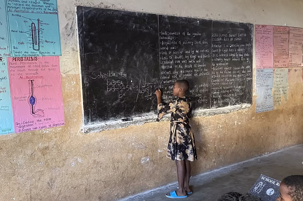 Girl writing on blackboard